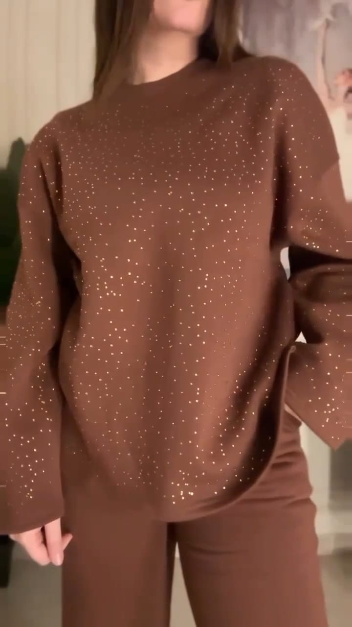 Brown outfit with bell sleeves worn by a person indoors.