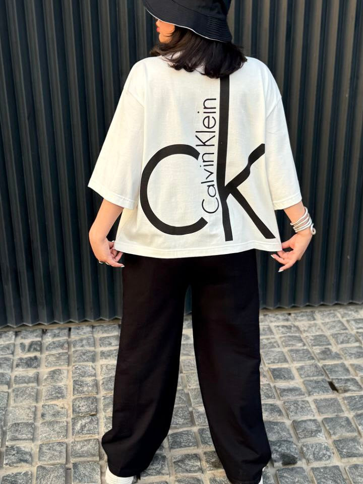 Chakoor Signature Co-ord set featuring an oversized t-shirt with a large Calvin Klein CK logo on the back and matching wide-leg trousers. 01