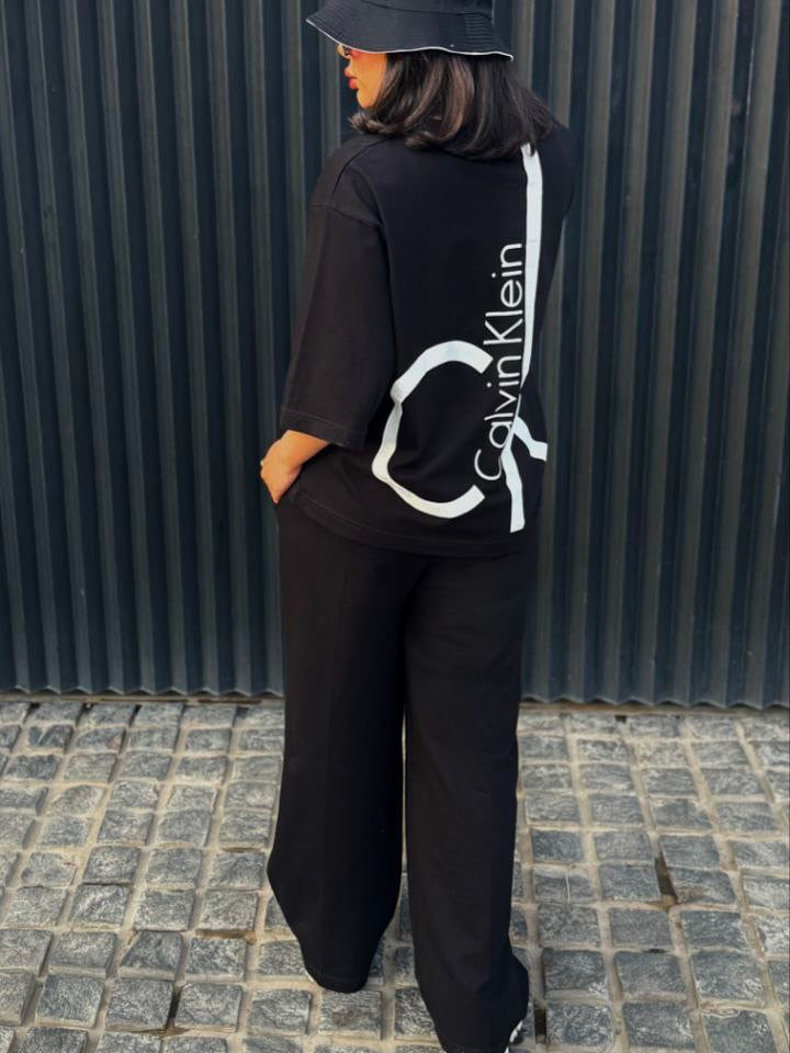 Chakoor Signature Co-ord set featuring an oversized t-shirt with a large Calvin Klein CK logo on the back and matching wide-leg trousers. 02