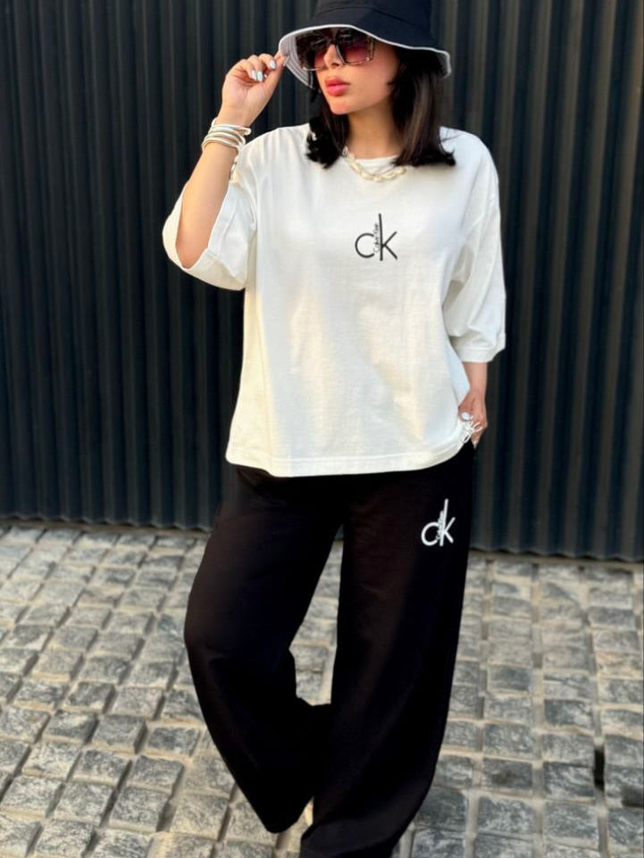 Chakoor Signature Co-ord set featuring an oversized t-shirt with a large Calvin Klein CK logo on the back and matching wide-leg trousers. 03