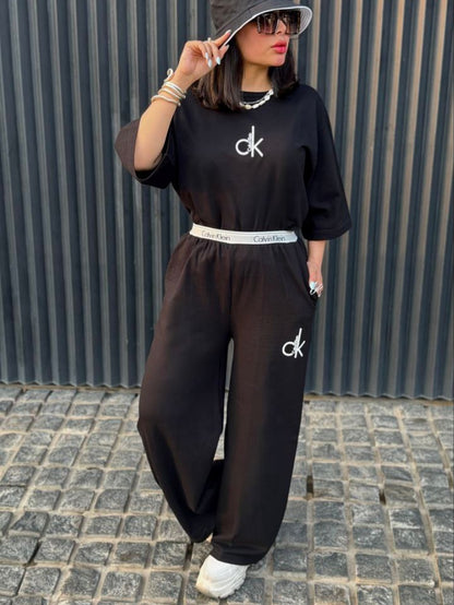 Chakoor Signature Co-ord set featuring an oversized t-shirt with a large Calvin Klein CK logo on the back and matching wide-leg trousers. 04