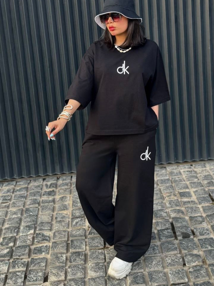 Chakoor Signature Co-ord set featuring an oversized t-shirt with a large Calvin Klein CK logo on the back and matching wide-leg trousers. 05