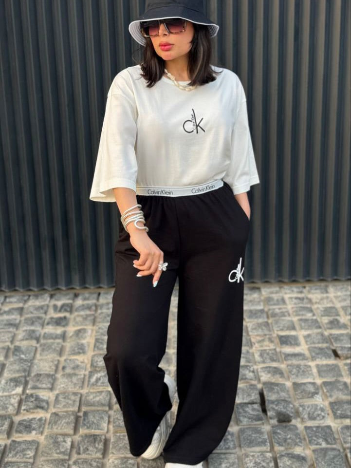 Chakoor Signature Co-ord set featuring an oversized t-shirt with a large Calvin Klein CK logo on the back and matching wide-leg trousers. 06