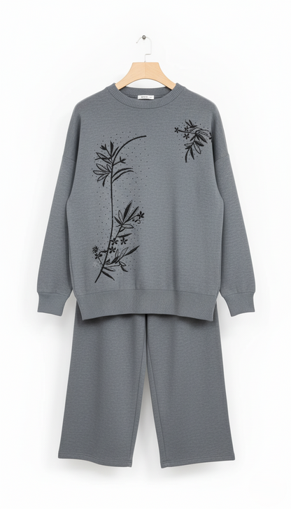Gray sweater and pants set with floral embroidery on a white background