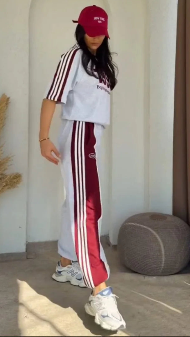 Grey 1993 graphic sweatshirt and matching wide-leg track pants set paired with white chunky sneakers 03