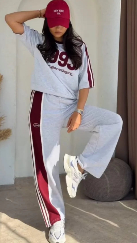 Grey 1993 graphic sweatshirt and matching wide-leg track pants set paired with white chunky sneakers 05