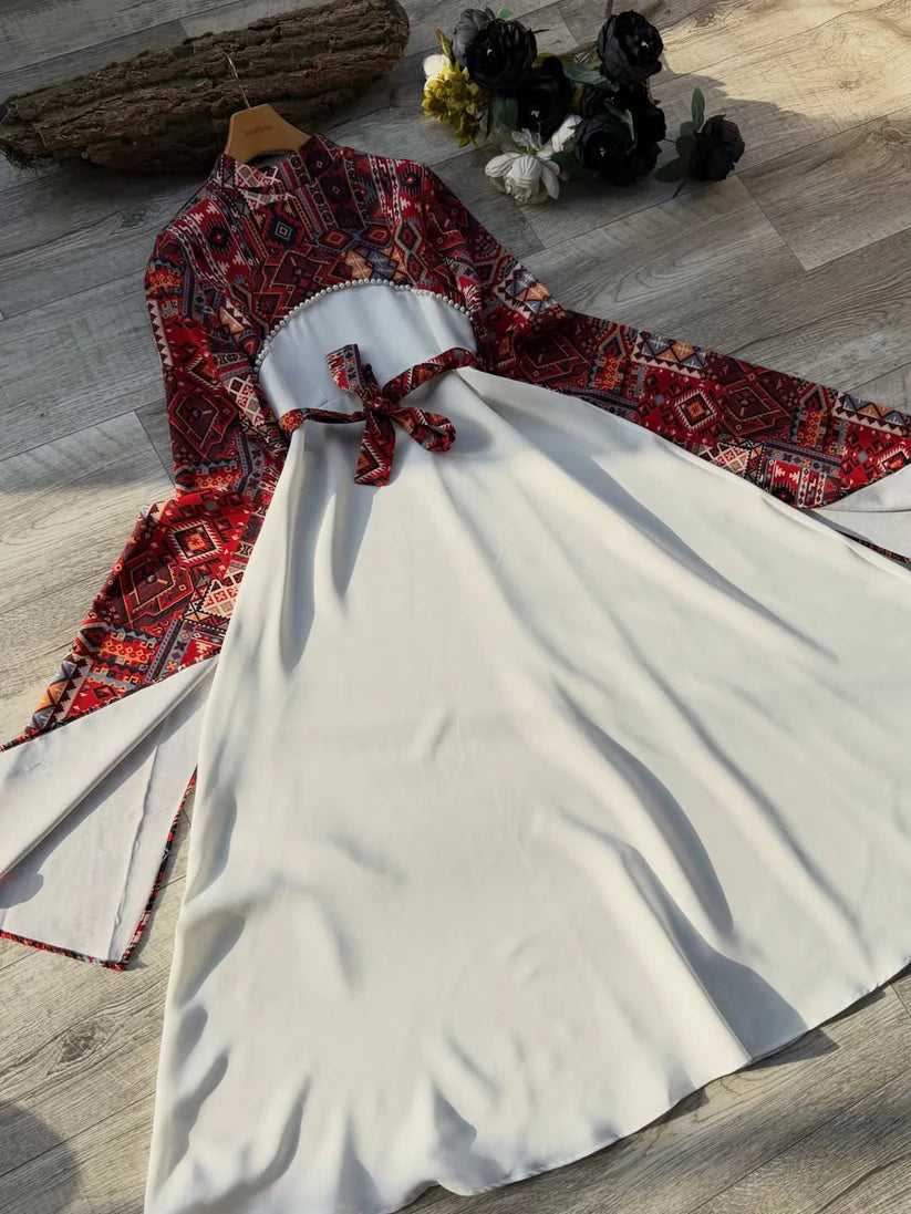 Long black dress with a red and blue geometric pattern on the bodice and wide sleeves, featuring a matching waist belt tied in a bow 03