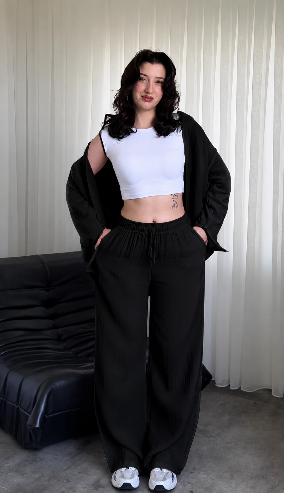 Minimalist two-piece shirt and trouser set with button-down top and elastic waist pants displayed on a chair with soft natural lighting, ideal for casual wear and everyday comfort 08