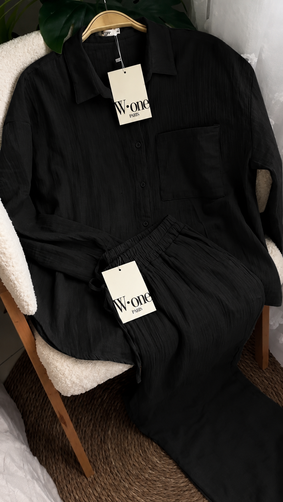 Minimalist two-piece shirt and trouser set with button-down top and elastic waist pants displayed on a chair with soft natural lighting, ideal for casual wear and everyday comfort 09