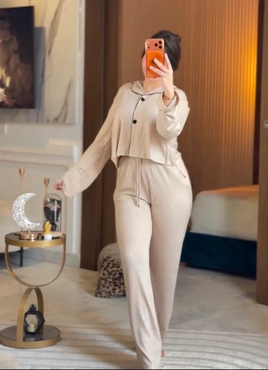 Stylish woman wearing a comfortable two-piece co-ord set with long sleeve top and loose fit pants, taking a mirror selfie in a modern bedroom setting, perfect casual loungewear outfit for women 01