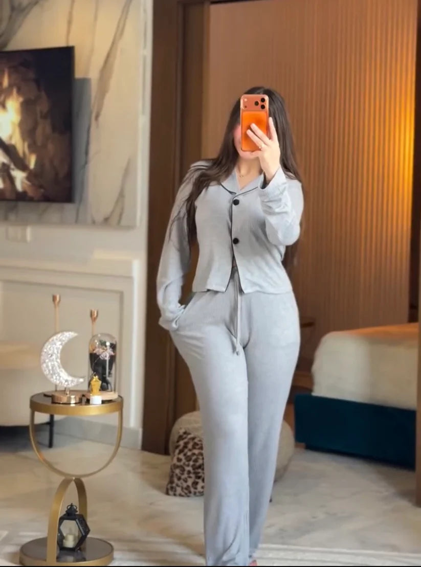 Stylish woman wearing a comfortable two-piece co-ord set with long sleeve top and loose fit pants, taking a mirror selfie in a modern bedroom setting, perfect casual loungewear outfit for women 02
