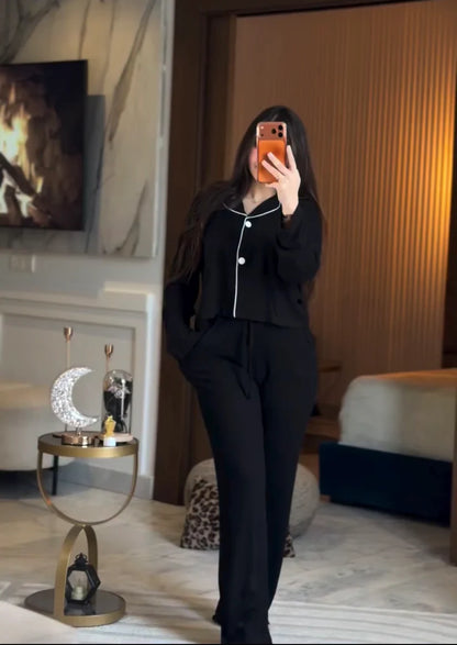 Stylish woman wearing a comfortable two-piece co-ord set with long sleeve top and loose fit pants, taking a mirror selfie in a modern bedroom setting, perfect casual loungewear outfit for women 05