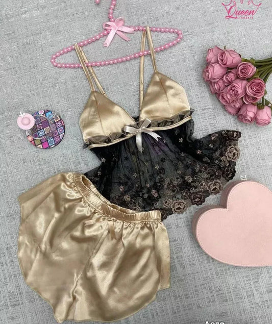Two-piece satin sleepwear set featuring a lace-trim camisole top with floral embroidery and matching shorts 01