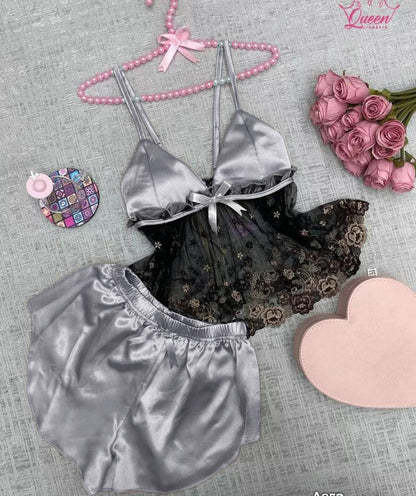 Two-piece satin sleepwear set featuring a lace-trim camisole top with floral embroidery and matching shorts 02