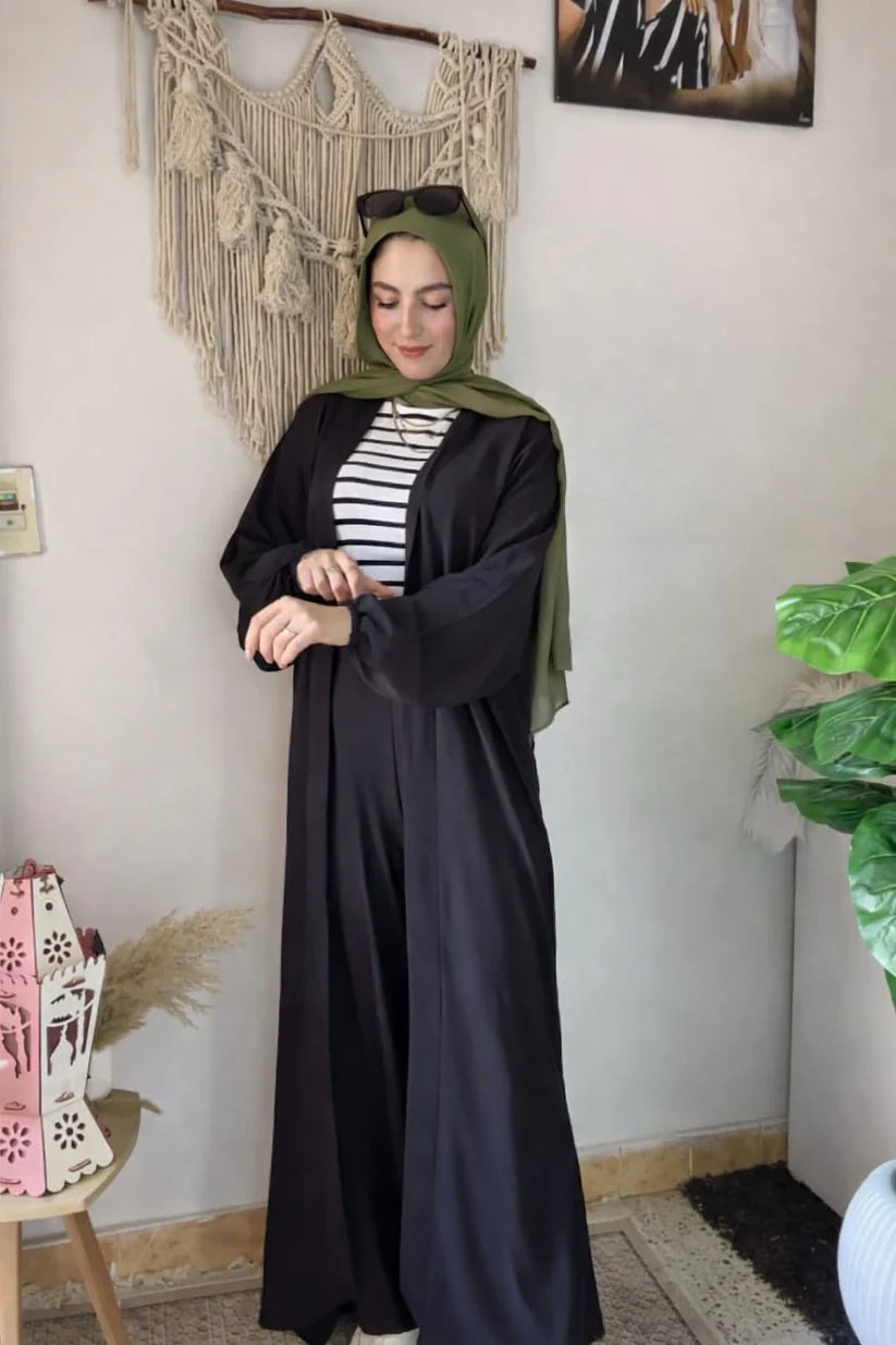 Woman wearing a chic beige three-piece modest ensemble with a long cardigan, wide-leg trousers, and a bold leopard print hijab 03