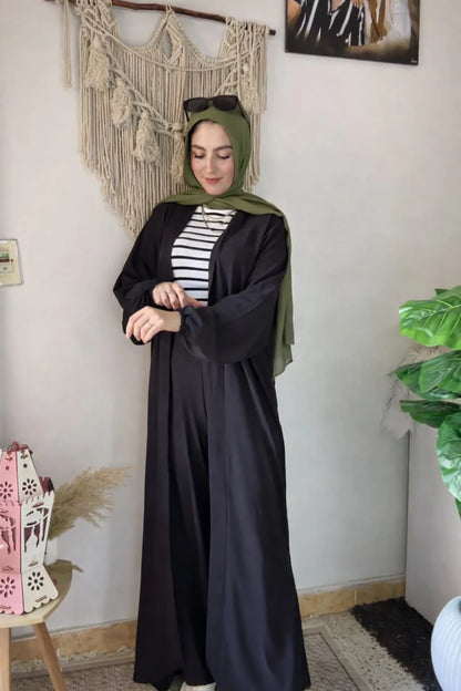 Woman wearing a chic beige three-piece modest ensemble with a long cardigan, wide-leg trousers, and a bold leopard print hijab 03