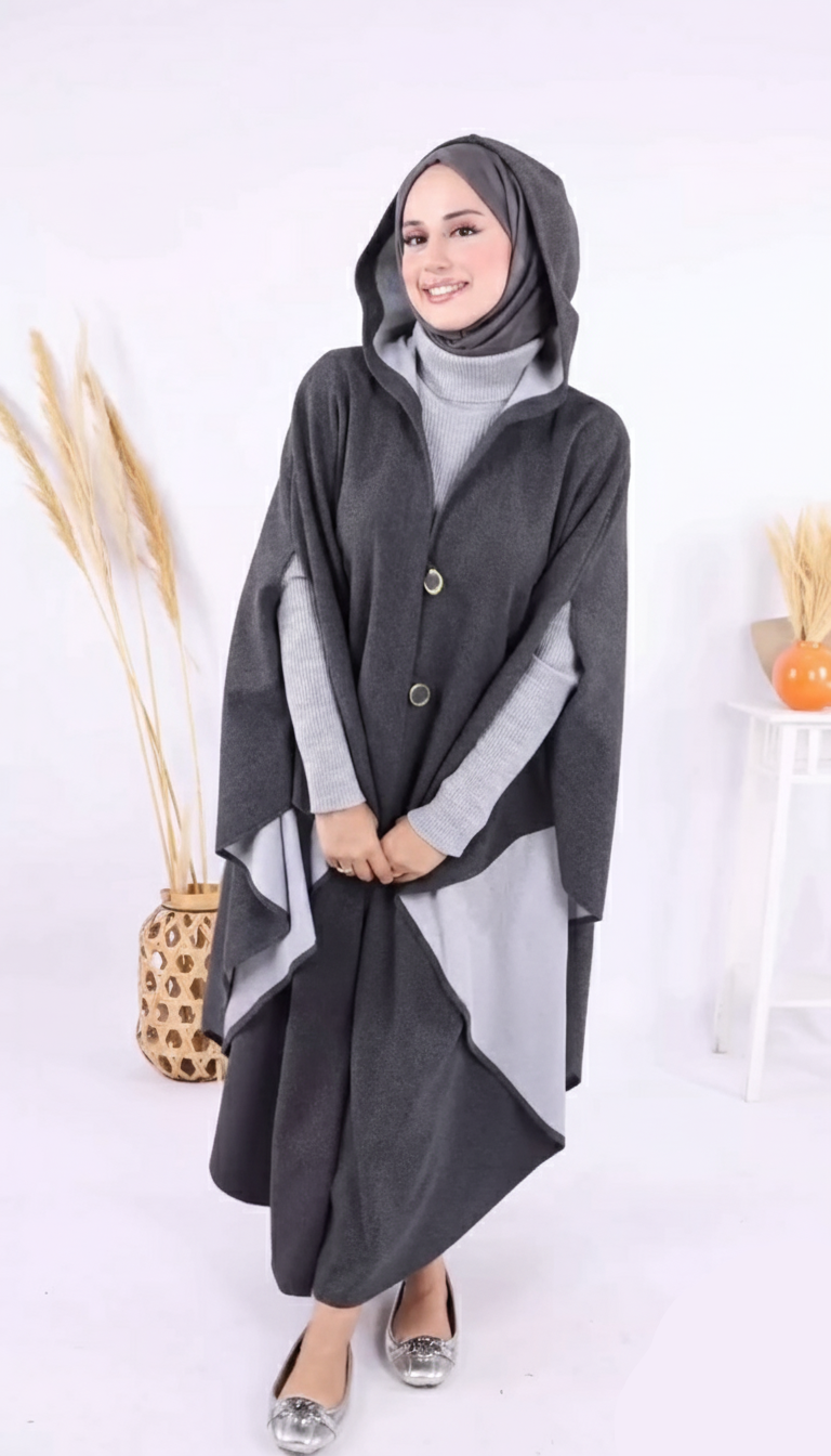Woman wearing a gray and white outfit with a hooded wrap on a white background